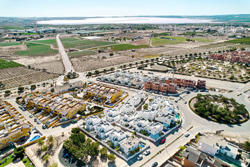 Aerial image panoramic photo Los Montesinos townscape with luxury villas, agricultural fields, salt lakes and countryside located in the province of Alicante, Valencian Community, Spain - 777597800