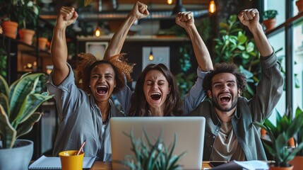 happy diverse team of successful professionals celebrates triumph in startup office. multiethnic group with laptop raises arms in joy and celebration