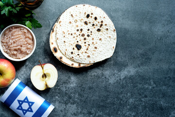 Handmade round Matzah in a plate on a concrete background. Saved Jewish Pesach Tradition. Jewish...