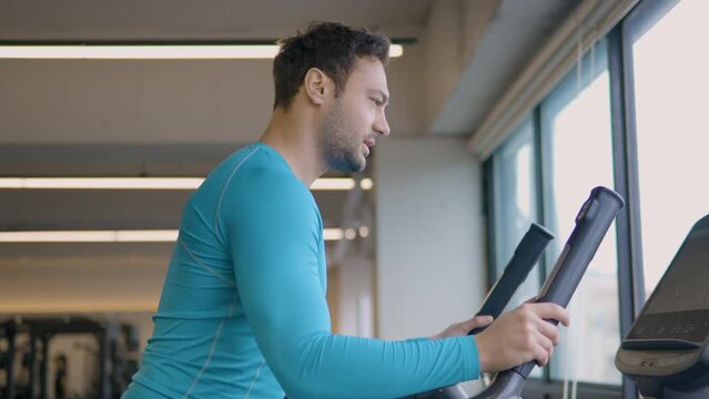 Sportsman Burn Calories Exercising on Stepmill Stepper Exercise Machine at Empty Gym - medium low angle