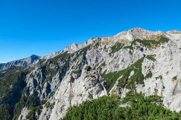 Panoramic view of majestic mountain ridges in wild Hochschwab massif, Styria, Austria. Scenic hiking trail along unique rock formations. Wanderlust in remote Austrian Alps in summer. Nature escapism