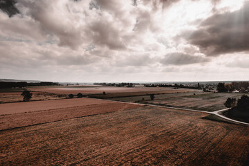 Empty rural fields in bright sunbeams