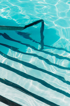 Pool steps and handrail in the summer sun