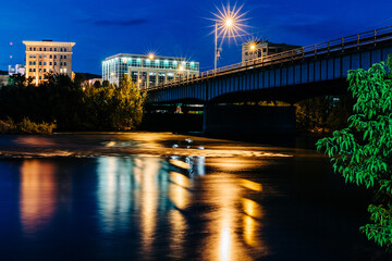Downtown Missoula and Clark Fork River at night with sunburst