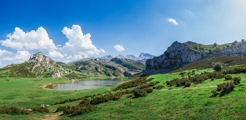 Fototapeta na wymiar Scenic view of Covadonga Lakes in Asturias, Spain against a cloudy blue sky