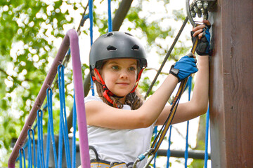 adventure climbing high wire park - people on course in mountain helmet