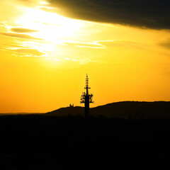 Sunset behind a ship silhouette on the sea horizon