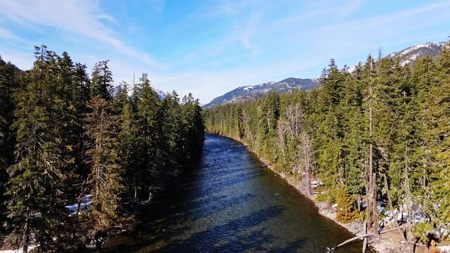 Forward scenic view of river and forest in Cle Elum with blue sky in Washington State.