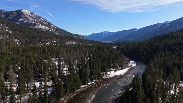 Beautiful Scenic shot of river and forest with snow capped mountain range in the background in Cle Elum on a clear day in Washington State