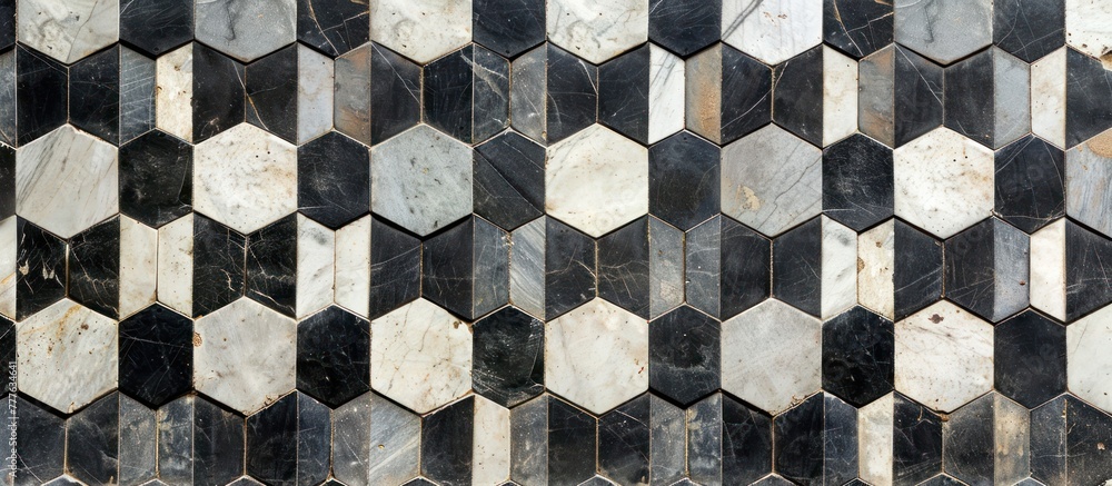 Poster a black and white tiled wall featuring hexagonal tiles in a patchwork pattern, creating a geometric 