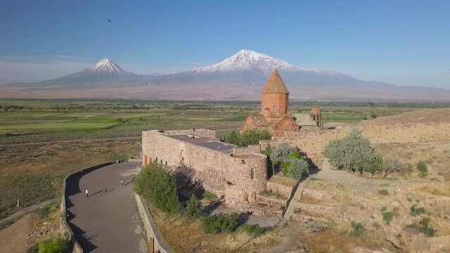 Pull-back aerial shot of Khor Virap with Mount Ararat in the background