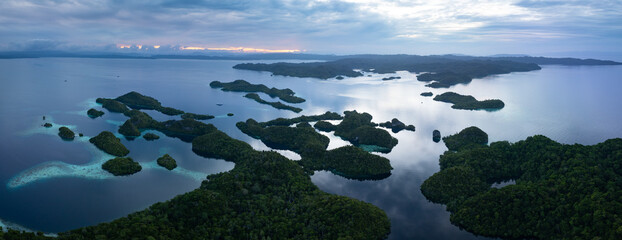 The scenic limestone islands of Pef, fringed by reef, rise from Raja Ampat's tropical seascape....