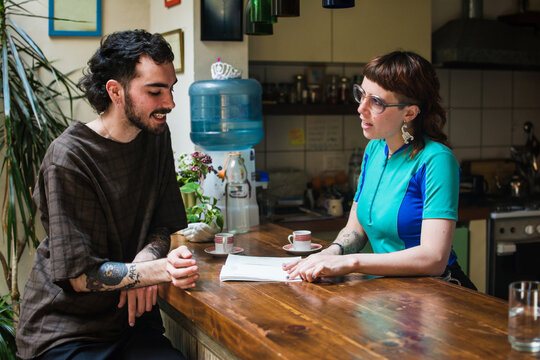 Client and artist discussing new tattoo design