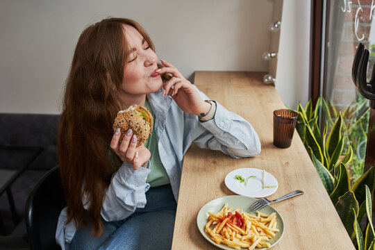 Woman eating hamburger