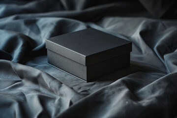 A stylish black paper mockup box rests on a dark velvet surface, suggesting luxury and exclusivity in presentation