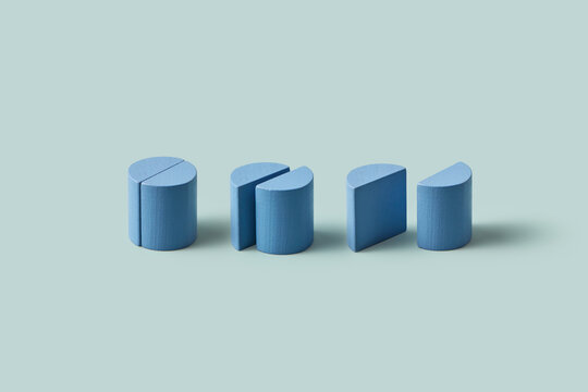 Three blue wooden cylinders divided in two pieces in studio
