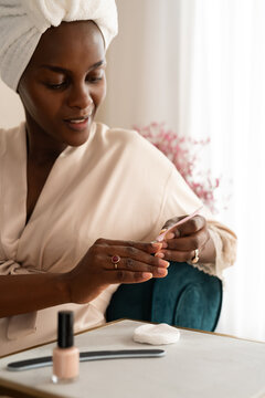 Woman removing cuticles with trimmer tool
