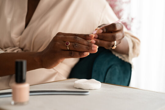 Anonymous woman removing cuticles 