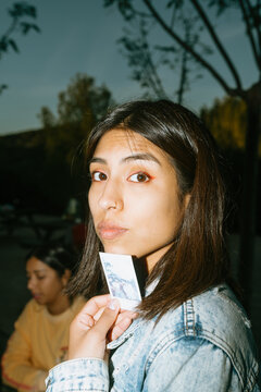 Woman Holding a Polaroid Picture