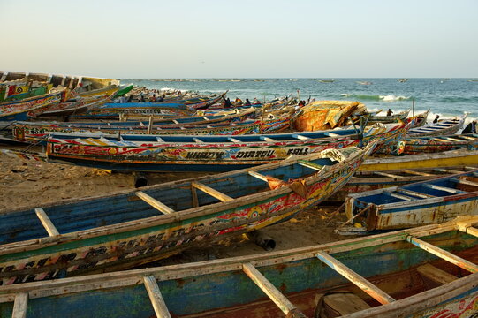 Nouakchott. Mauritania. October 04, 2021. Hundreds of huge painted wooden boats, on which local fishermen go to sea, are parked on the shore of the Atlantic Ocean. Each boat is painted individually.