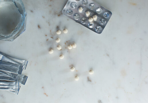HRT medication on a white marble background