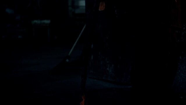 Camera Tracking the Rope or Cable Tilt Up to the Factory Man Working in the Plant of Metal Production. Welding, Casting, Foundry Light, Sparks. Metallurgy. Epic and Cinematic shot. Slow Motion