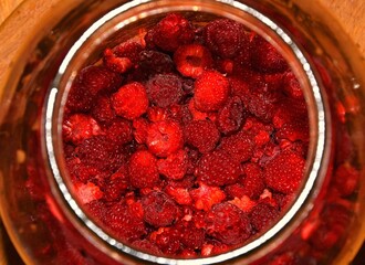 In the jar, sweet raspberries prepared for alcohol tincture