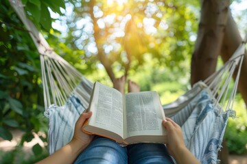 Relaxing in a hammock with a book in a green, sunlit garden