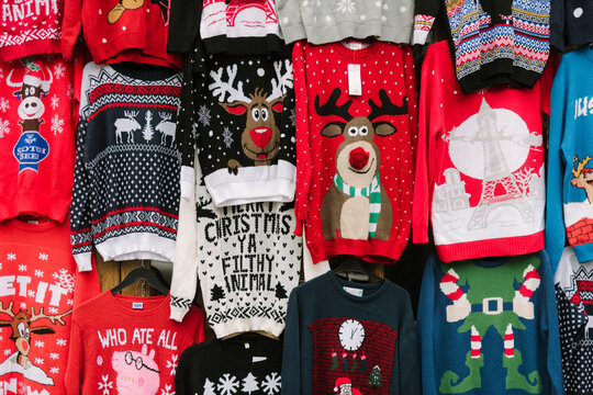 Christmas sweaters hanging from the wall in a Market 
