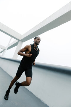 Crooked perspective image of a young black man running