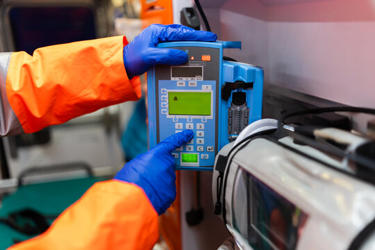 close-up of a person's hands using an electronic medical device