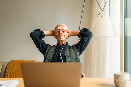 Senior man watching his video on his laptop