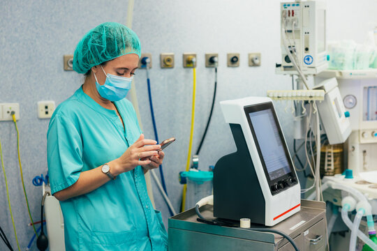 Surgeon using smartphone in a high-tech operating room