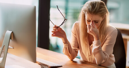 Computer, headache or stress and business woman at desk in office with deadline pressure. Anxiety,...