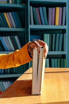 Anonymous person putting hand on book 
