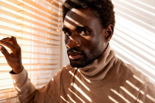 man closeup by the window