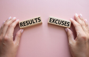 Results or Excuses symbol. Concept word Results or Excuses on wooden blocks. Businessman hand....