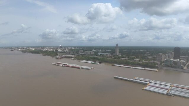 Aerial of barges on the Mississippi River and the skyline of Baton Rouge City in the background