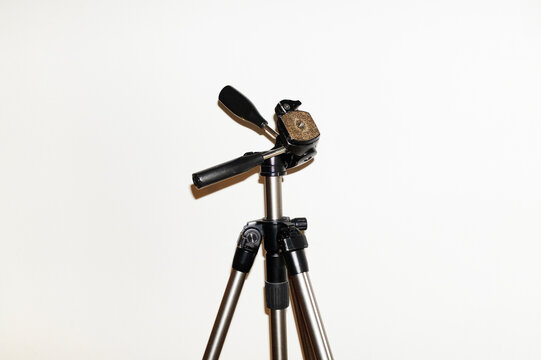 Close-up of a camera photography tripod with hard direct flashlight