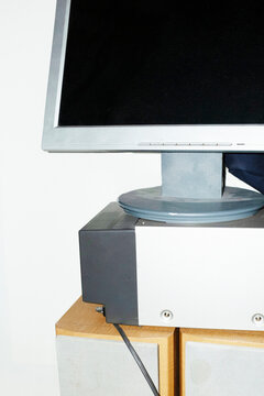 Close-up of computer screen and speakers on a office with flashlight