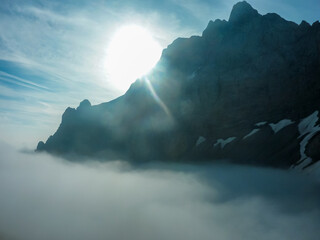 Panoramic view of mountain peaks above clouds of majestic Carnic Alps, Carinthia, border Italy...