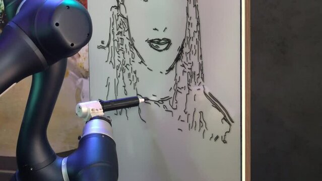 Futuristic robot arm with marker drawing portrait of woman on whiteboard in exhibition