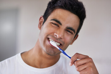 Happy, portrait and man with toothbrush in bathroom for dental hygiene, gum disease and oral care....