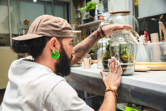 Man cleaning a terrarium