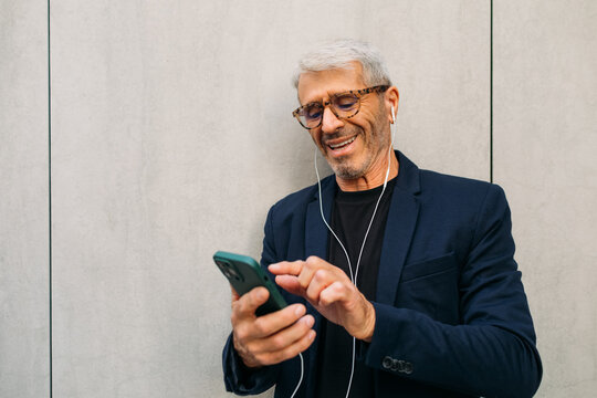 Senior man using cell phone outside