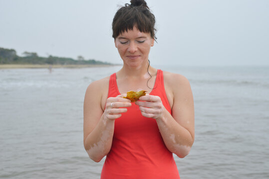 Woman in a swimsuit with a crab shell
