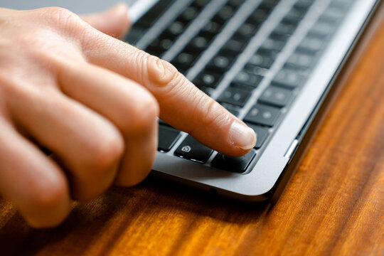Men hand on laptop keyboard