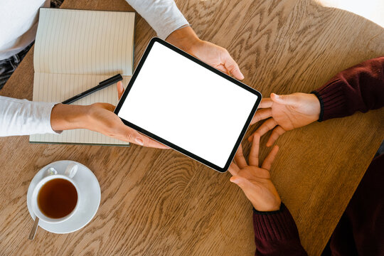 A tablet with a white screen on the table