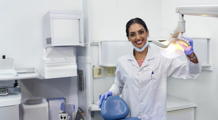 Dentist, portrait and woman by xray machine with smile for mouth care, dental health and service....