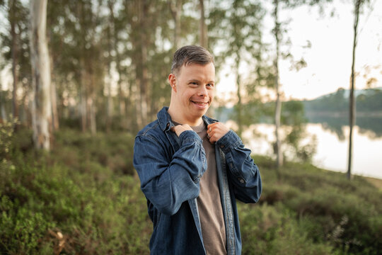 portrait of young man with down syndrome in nature